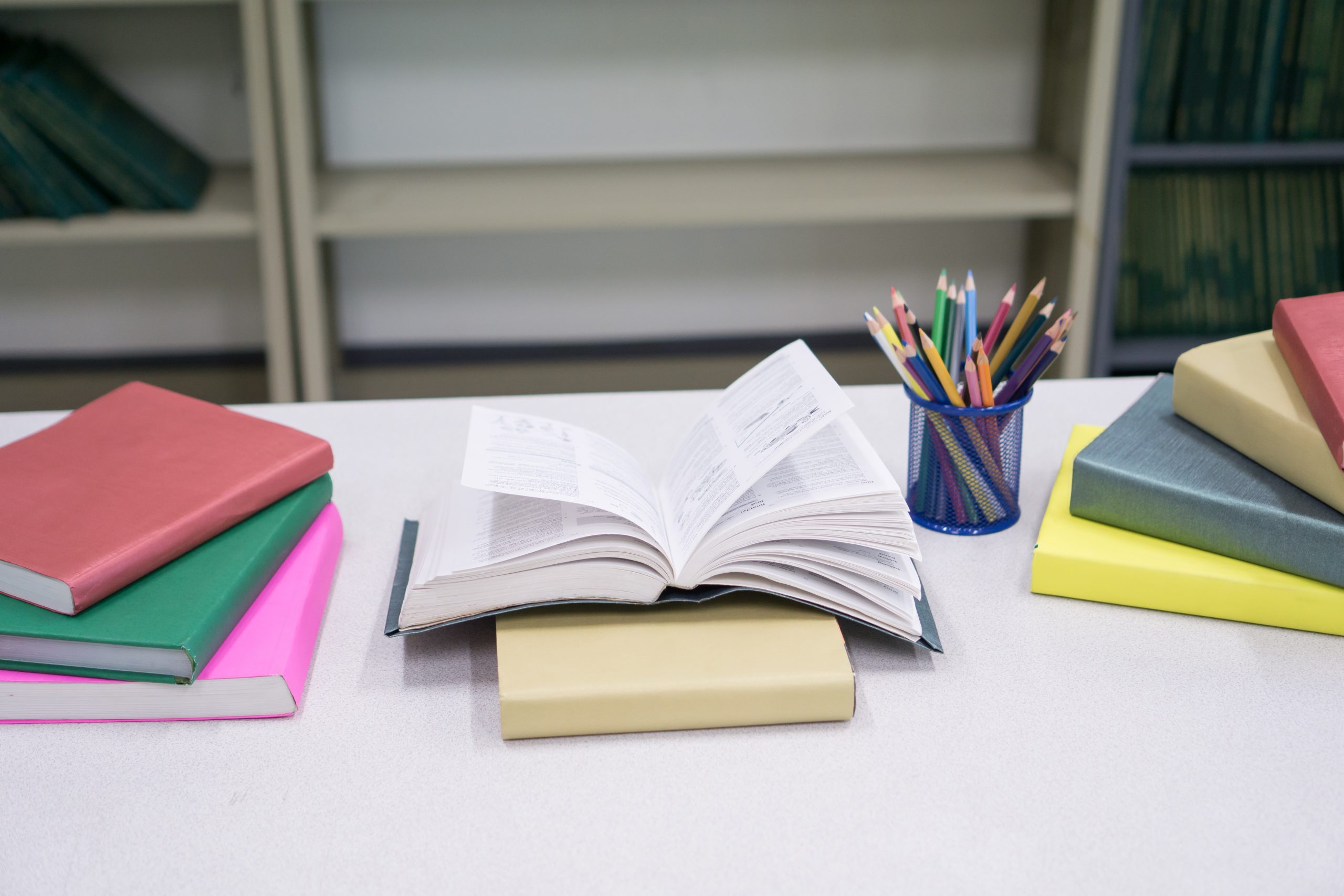 Image of Pile of books and stationery at library. Education conc